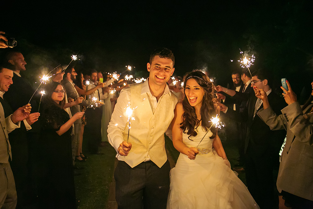 Newlyweds enjoy sparklers during their evening wedding reception at Braxted Park wedding venue in Essex