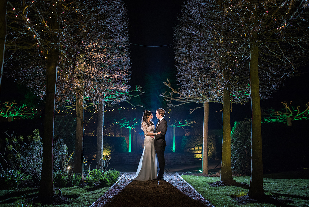 The newlyweds enjoy the gardens at Braxted Park during their evening wedding reception